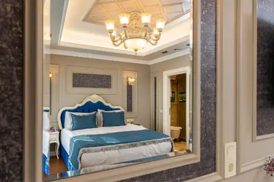 a reflection of a bedroom with a bed in a mirror at Begonville Mansion Oldcity in Istanbul