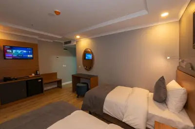 a hotel room with a bed and a television at New Emin Hotel in Istanbul