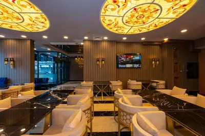 a restaurant with white chairs and a bar at New Emin Hotel in Istanbul