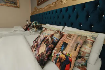 a bed with a bunch of pillows on it at Constantinopolis Hotel in Istanbul