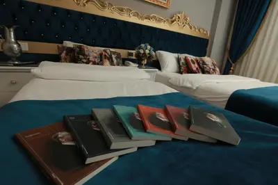 a pile of books sitting on top of two beds at Constantinopolis Hotel in Istanbul