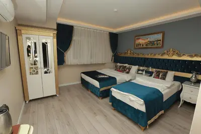 a hotel room with two beds and a window at Constantinopolis Hotel in Istanbul