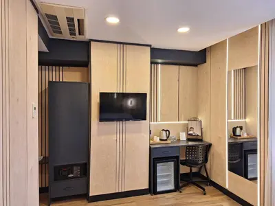 a kitchen with a desk and a tv in a room at N'Ala Otel in Sakarya