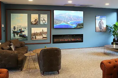 a living room with furniture and a flat screen tv at Kerthill Hotel in Istanbul