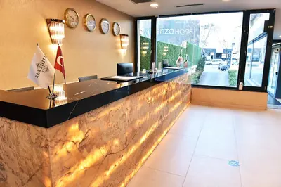 a restaurant lobby with a counter and clocks on the wall at Kerthill Hotel in Istanbul