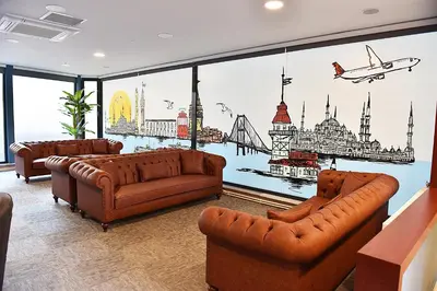 a living room with three couches and a mural of cities at Kerthill Hotel in Istanbul