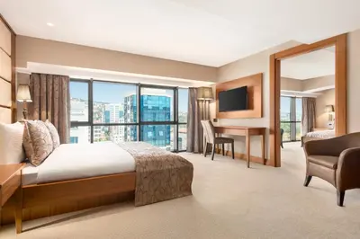 a hotel room with a bed and a desk with a monitor at Days Hotel by Wyndham Istanbul Maltepe in Istanbul