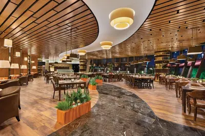 a restaurant with wooden ceilings and tables and chairs at Days Hotel by Wyndham Istanbul Maltepe in Istanbul