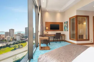 a hotel room with a bed and a desk and a television at Days Hotel by Wyndham Istanbul Maltepe in Istanbul