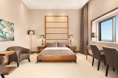 a bedroom with a bed and a desk and chairs at Days Hotel by Wyndham Istanbul Maltepe in Istanbul