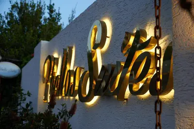 a sign on a building that says the word hotel at Phellos Suites Boutique Hotel in Sile