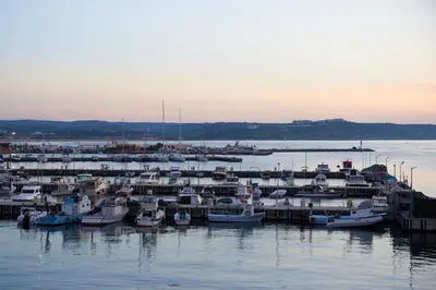 a group of boats docked at a dock in the water at Phellos Suites Boutique Hotel in Sile