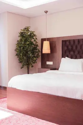 a bedroom with a large bed and a potted plant at Phellos Suites Boutique Hotel in Sile