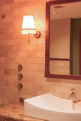a bathroom with a sink and a mirror and a lamp at Phellos Suites Boutique Hotel in Sile