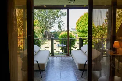 a balcony with white chairs and a view of the city at Phellos Suites Boutique Hotel in Sile