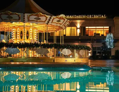a swimming pool in front of a building at night at Mandarin Oriental Bosphorus, Istanbul in Istanbul