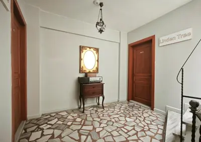 a hallway with a door and a table and a mirror at Sultanahmet Enjoyer Suites in Istanbul