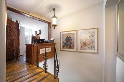 a woman is sitting at a desk in a room at Sultanahmet Enjoyer Suites in Istanbul