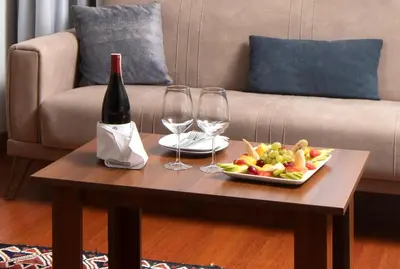 a table with a plate of fruit and wine glasses at Sultanahmet Enjoyer Suites in Istanbul
