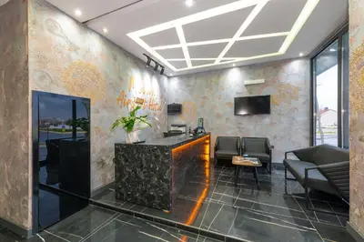 a lobby with a reception desk and a tv at Melanj Airport Hotel in Arnavutköy