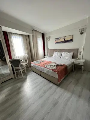 a bedroom with a bed and a table and chairs at Nacre Residence in Istanbul