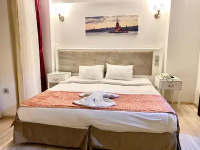 a bedroom with a bed with a towel on it at Nacre Residence in Istanbul