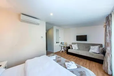 a living room with a bed and a couch at Nacre Residence in Istanbul
