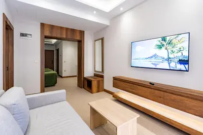 a living room with a couch and a tv on a wall at Mardy Suit Hotel in Istanbul