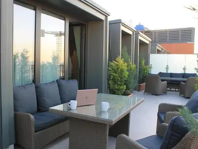 a patio with a table with a laptop on it at Garlon Residence in Istanbul