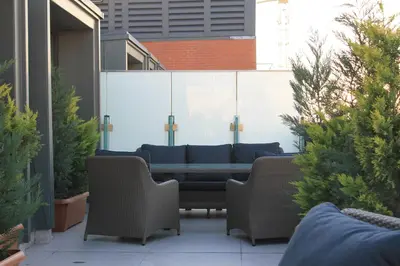 a patio with a table and chairs and some plants at Garlon Residence in Istanbul
