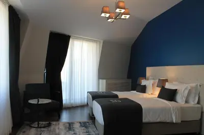 a hotel room with two beds and a window at Garlon Residence in Istanbul