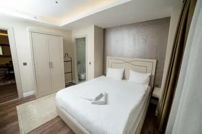 a white bed with a pair of shoes on it at The Charm Hotel - Old City in Istanbul