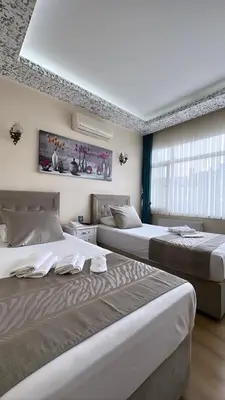 a bedroom with two beds and a window at ÜSKÜDAR OTEL in Istanbul
