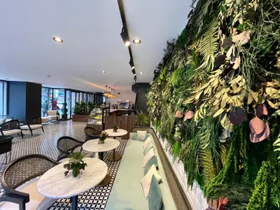 a restaurant with tables and a green wall at Weingart Istanbul in Istanbul