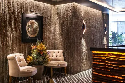a lobby with two chairs and a table and a clock at Weingart Istanbul in Istanbul