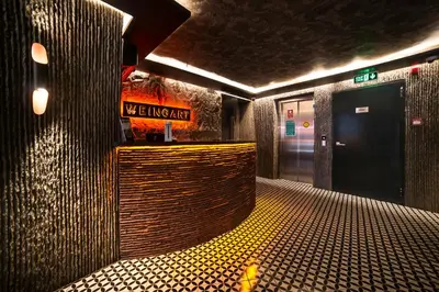 a hallway of a building with a restroom with a sign at Weingart Istanbul in Istanbul