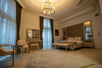 a bedroom with a bed and a chandelier at BANDIRMA PALAS OTEL in Bandırma