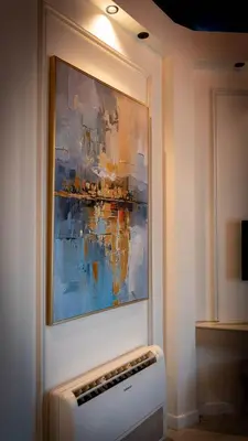 a painting hanging on a wall with a radiator at BANDIRMA PALAS OTEL in Bandırma