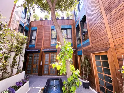 an exterior view of a house with a tree at Henna Hotel Istanbul in Istanbul