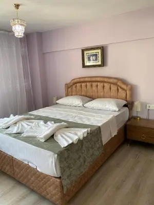 a bedroom with a large bed with white sheets at Garden House in Istanbul