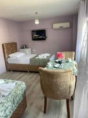 a hotel room with two beds and a table and chairs at Garden House in Istanbul