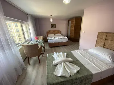 a hotel room with a bed and a table with towels at Garden House in Istanbul