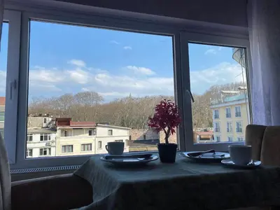 a table with a view of a city from a window at Garden House in Istanbul