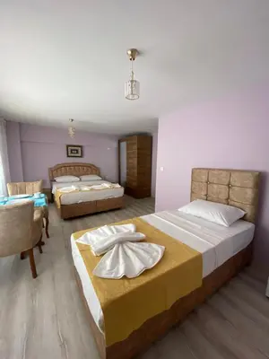 a bedroom with two beds and a table and chairs at Garden House in Istanbul