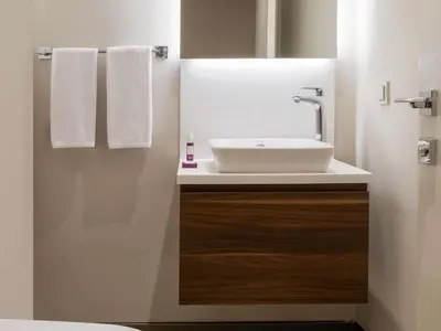 a bathroom with a white sink and towels at Movenpick Living Istanbul West in Istanbul