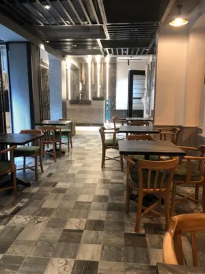 a dining room with wooden tables and chairs at Taksim Galatist Hotel in Istanbul