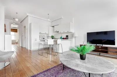 a living room with a table and a kitchen at NOA - Tatar Beyi 18 in Istanbul