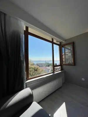 an empty room with a large window and a couch at Hotel Peninsula in Istanbul
