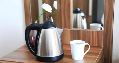 a black and silver coffee pot and a cup on a shelf at Burçman Hotel Vişne in Yıldırım