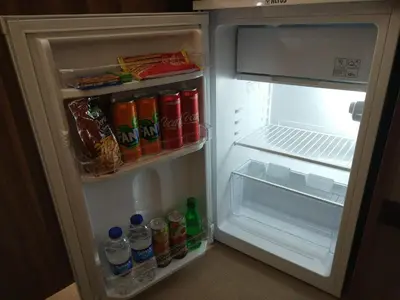 an open refrigerator filled with drinks and water bottles at Burçman Hotel Vişne in Yıldırım